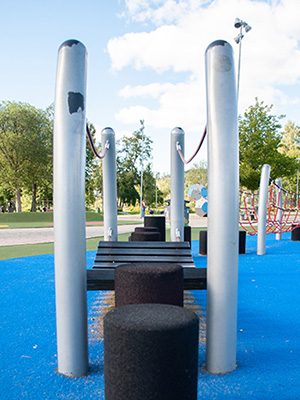 An obstacle course with a low angle view of the stepping stones leading to the tight rope challenge.